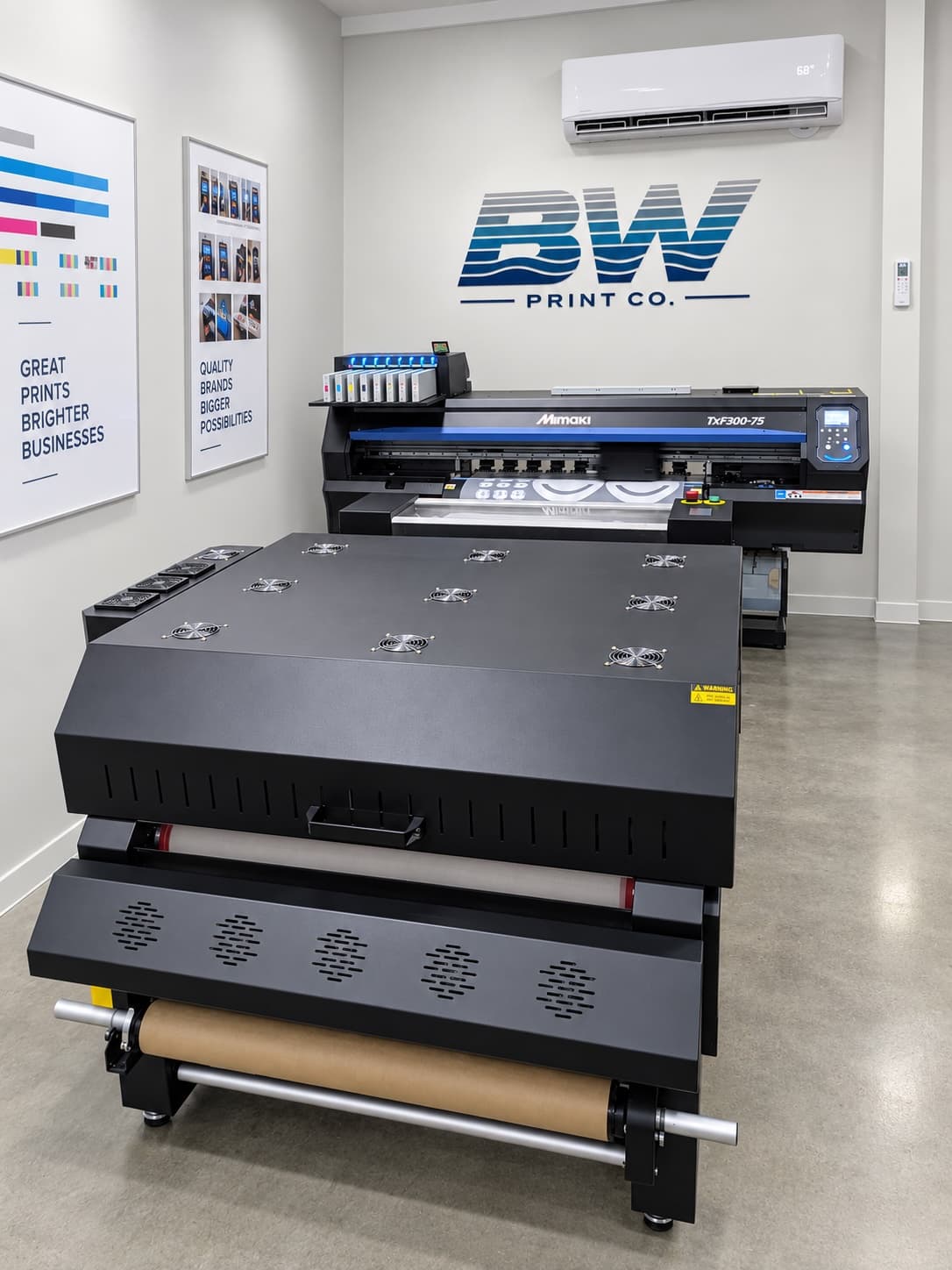 The Big Water Print Co. shop: DTF printer and curing line under the BW logo