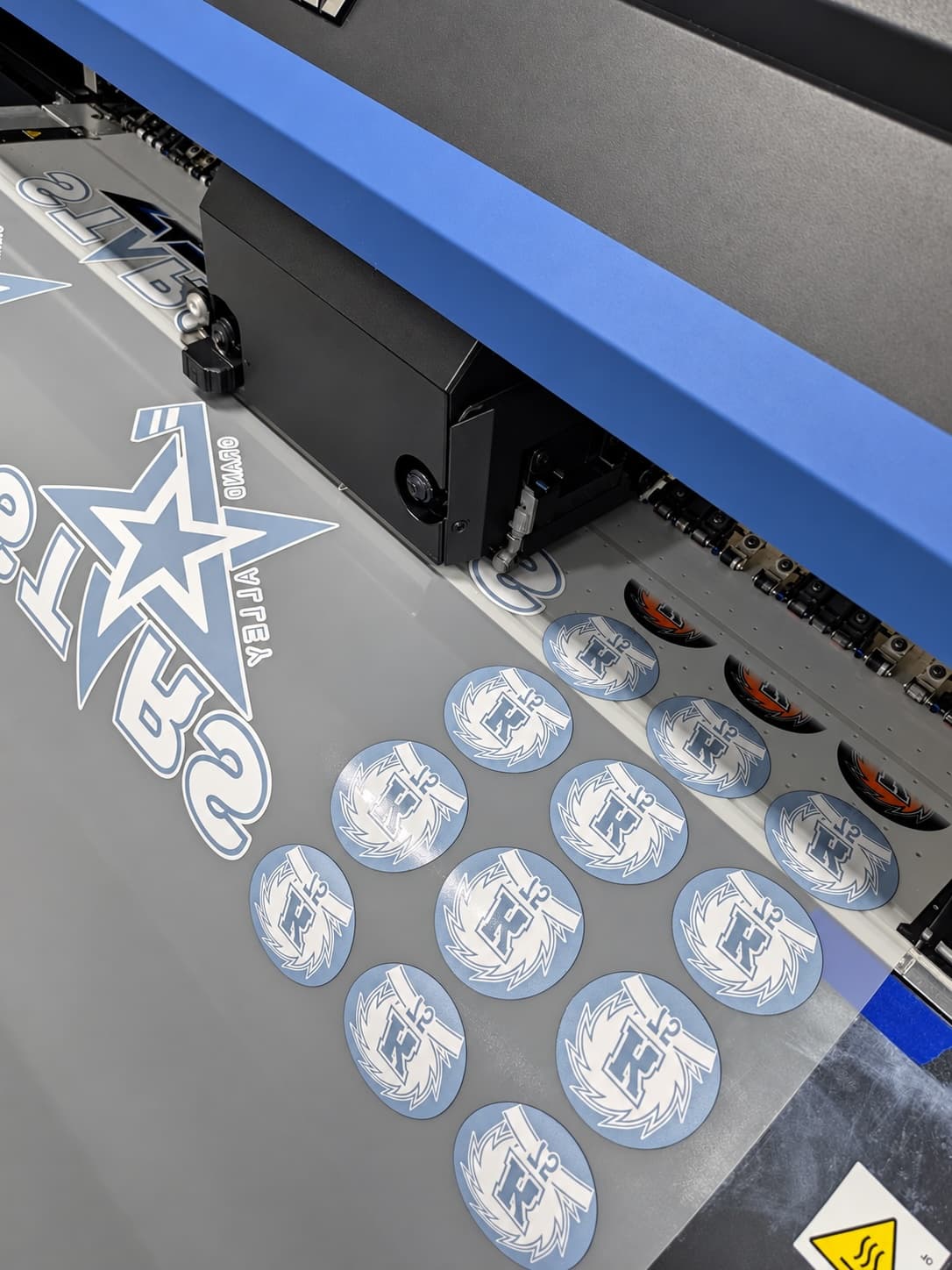 Print head laying down team logos on a gang sheet