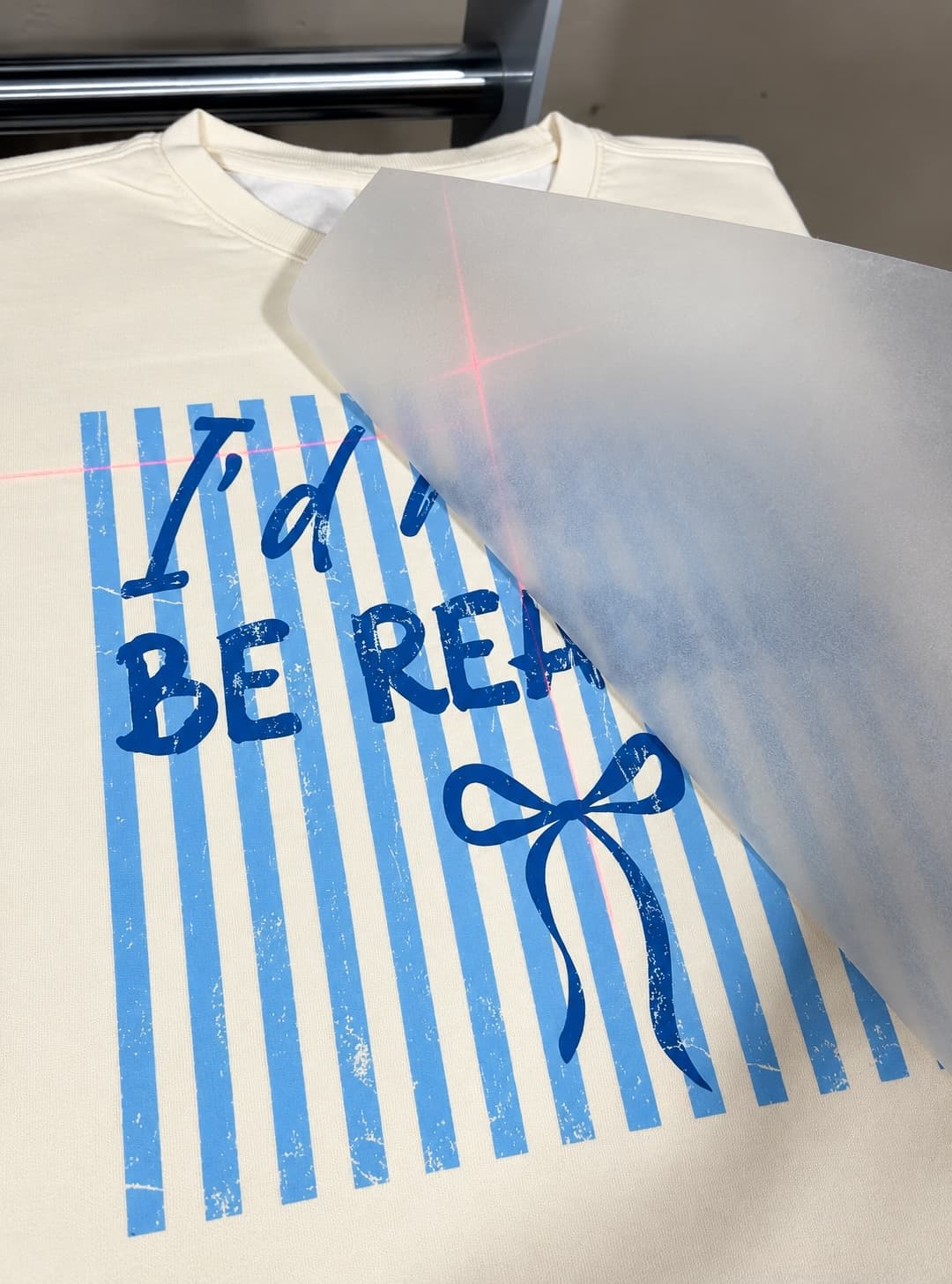 Peeling the film from a freshly pressed DTF transfer